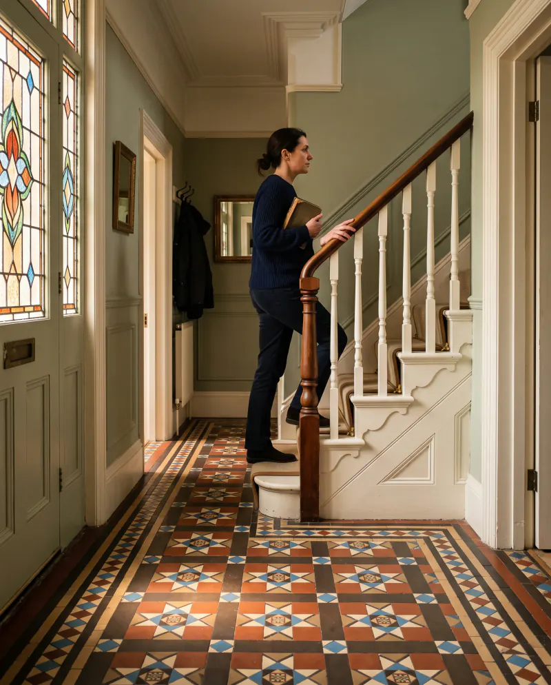 Late afternoon light across the hallway of a Victorian terraced house with original floor tiles
